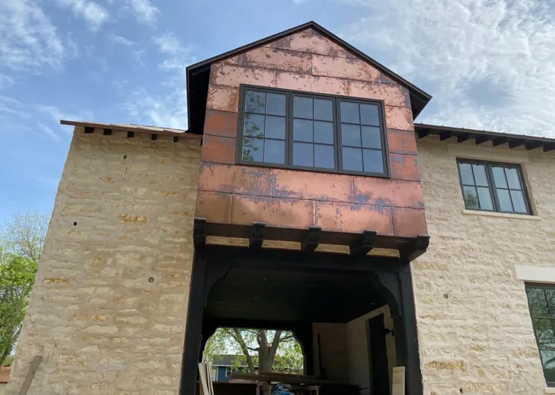 Copper metal panel facade on a stone building for Metal Roof Coating in Wollochet