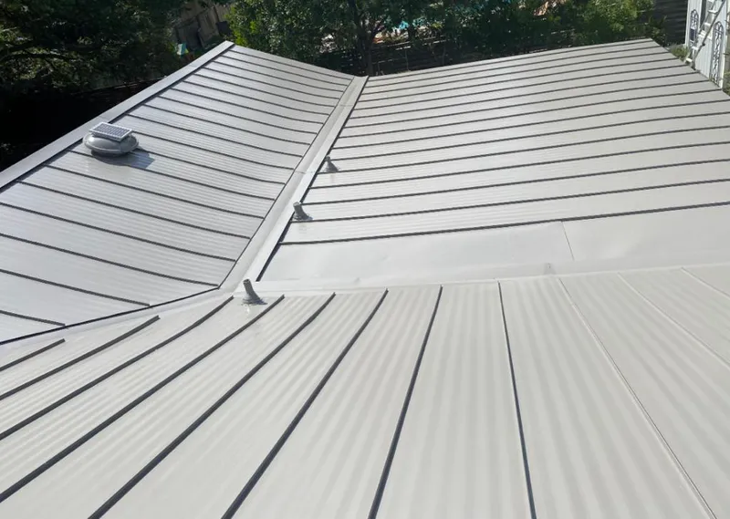 Solar attic fan installed on a metal roof for Roof Ventilation in Wollochet